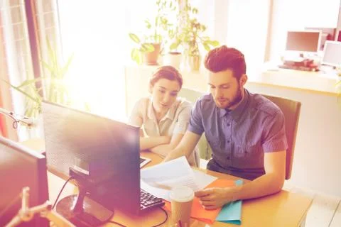 Creative team with computer and papers in office Stock Photos