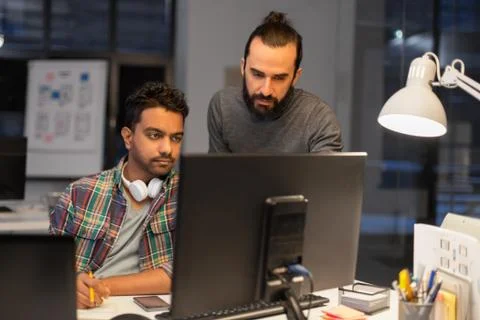 Creative team with computer working late at office 스톡 사진