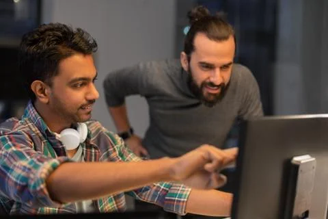 Creative team with computer working late at office 스톡 사진