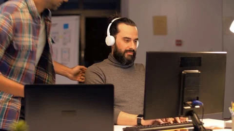 Creative team with computers works at night office Stock Footage 87122717