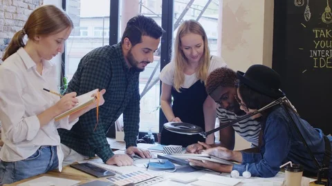Creative Team of Designers Discussing Project on Tablet Stock Footage 115461746