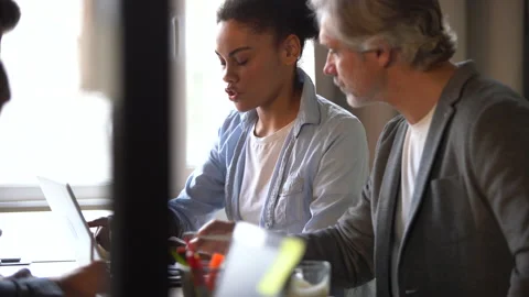 Creative team discussing new project. Casual young people in new business office Stock Footage 171788027