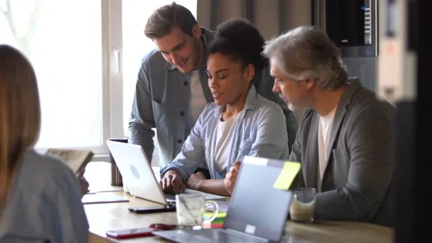 Creative team discussing new project. Casual young people in new business office Stock Footage 171788400