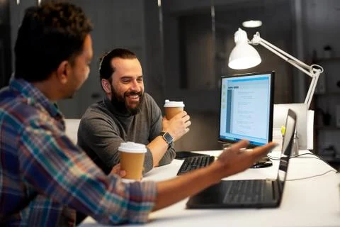 Creative team drinking coffee at night office Stock Photos