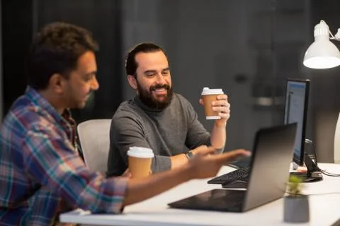 Creative team drinking coffee at night office Foto stock