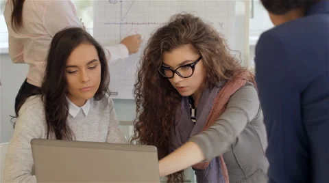 Creative team of four women work actively at the office Video stock 68979219