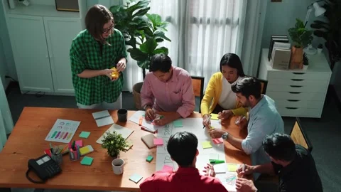 Creative team making scrum task board while using sticky note. Convocation. Stock Footage 283886396