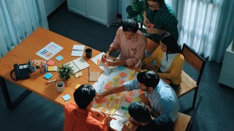 Creative team making scrum task board while using sticky note. Convocation. 写真素材