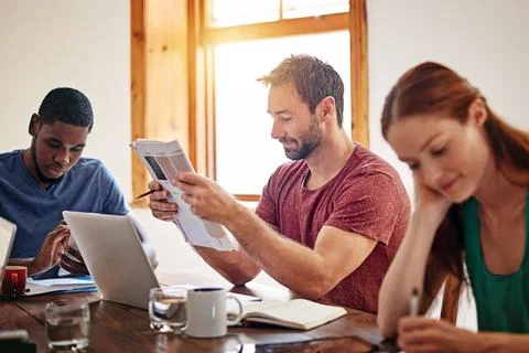 Creative team, manager and reading with laptop, design proposal and planning for Stock Photos