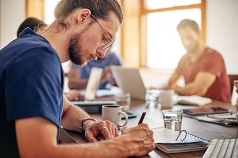 Creative team, manager and writing in meeting, design proposal or planning for Stock Photos