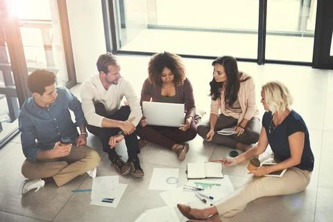 Creative, team or meeting with notebook on floor for campaign brief, logo d.. Stock Photos