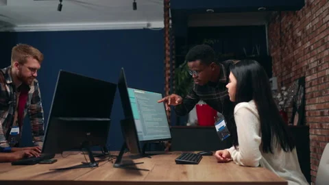 Creative team of programmers and data scientists working together in office in Stock Footage 233725059