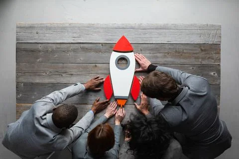 Creative team with startup rocket Stock Photos