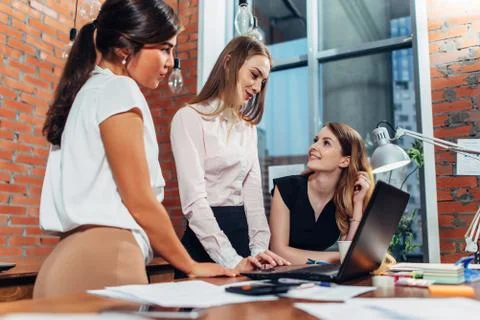 Creative team working on new project together looking and listening to their Stock Photos