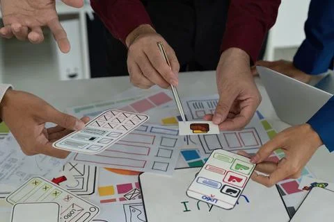 Creative Teamwork in UX UI Design. Designers engaging in a lively discussion 스톡 사진