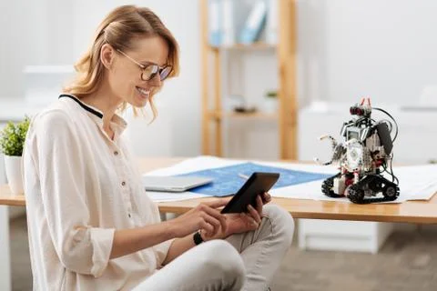 Creative technology specialist testing automatic robot indoors Stock Photos