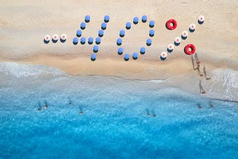 Creative text - 40 made from colorful umbrellas on sandy beach Stock-Fotos