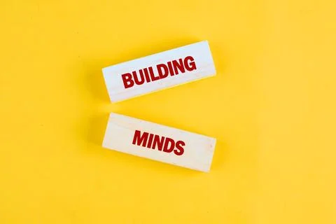 Creative text blocks display the phrase building minds, representing modern a Stock Photos