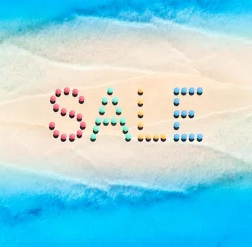 Creative text made from umbrellas on empty sandy beach, blue sea Foto stock