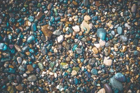 Creative textured pebble beach background for copy space Stock Photos