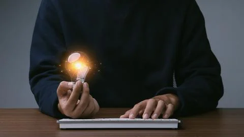 Creative thinking idea for Tecnology concept.Hand of young man holding ligh.. Stock Photos