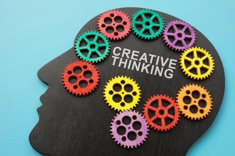 Creative thinking sign on the head shape and cog wheels. Stock Photos