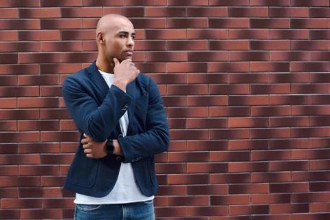 Creative thinking. Young guy standing on wall thoughtful Foto stock