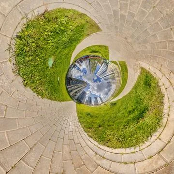 Creative tiny planet photo of a rural landscape with dirt road, green field.. Stock Photos