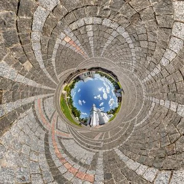 Creative tiny planet photo of a rural landscape with dirt road, green fields, Foto stock