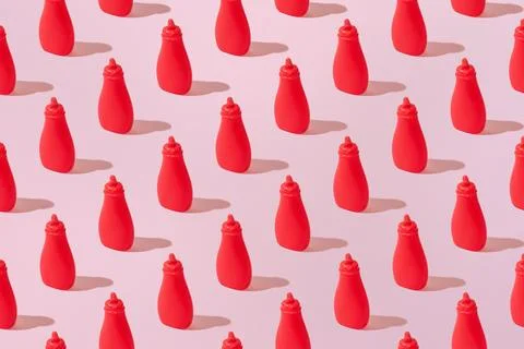 Creative tomato ketchup pattern flat lay on pastel pink background minimalism Stock Photos