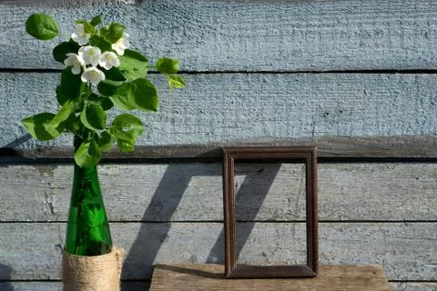 Creative top view apple tree blooming flowers brunch in green glass bottle  o Stock Photos