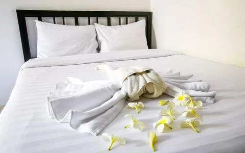Creative Towel Sculptures With Flowers In Luxury Tropical Hotel Bed Thailand. Stock Photos