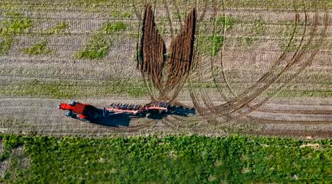 Creative tractor driver drew a butterfly on the field aerial view Stock Photos