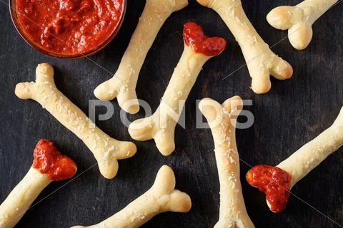 Creative traditional Halloween dough spooky witch bones cookies vegetarian treat Stock Photos