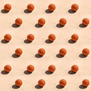 Creative trendy pattern made with basketball ball on concrete surface casti.. Stock Photos