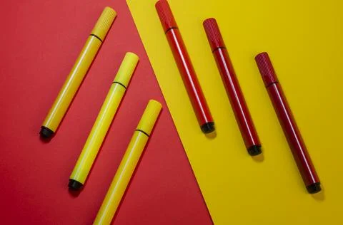 Creative two-color composition with red and yellow felt-tip pens. Stock Photos