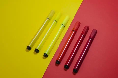 Creative two-color composition with red and yellow felt-tip pens. Stock Photos