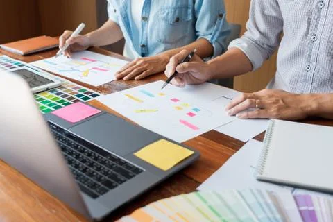 Creative UI designer teamwork meeting planning designing wireframe layout  ap Stock Photos