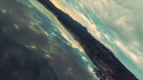 Creative upside down aerial rotation over lake with mirrored clouds 库存影片 328898303