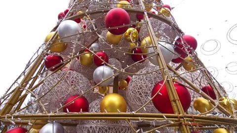 A creative urban Christmas tree made of red, silver and gold balls Stock Footage 323510092