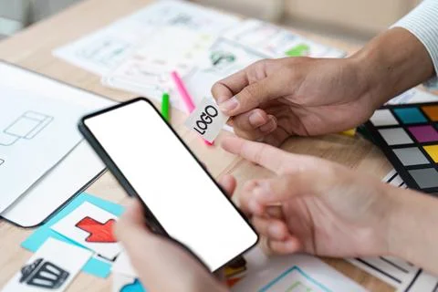 Creative UX UI Design Process with Mobile App Interface and Logo Concept on Desk Stock Photos