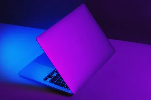 Creative version of an half opened laptop computer with purple and blue color Stock Photos