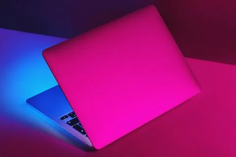 Creative version of an half opened laptop computer with purple and blue color Stock Photos