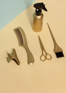 Creative vertical banner with gold colored barber tools. Hair salon accessories Stock Photos