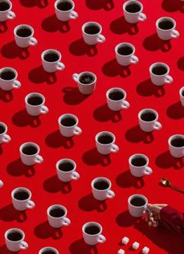 Creative vertical pattern of various coffee mugs on red Stock Photos
