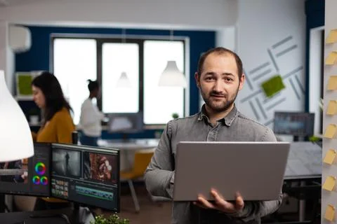 Creative video editor worker standing in front of camera Stock-Fotos