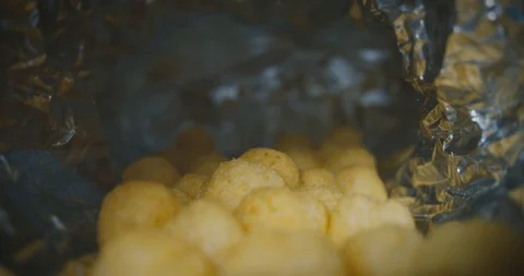 Creative view from inside an cracker packaging bag. Slow dolly out shot Stock Footage 127760156