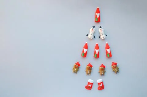 Creative walking Christmas tree made of New Year symbols decorations on grey Stock Photos