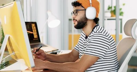 Creative, web designer and man on computer with headphones for software, graphic Stock Photos