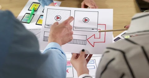Creative web site developers create interface design from sketches.  Stock Footage 201746978